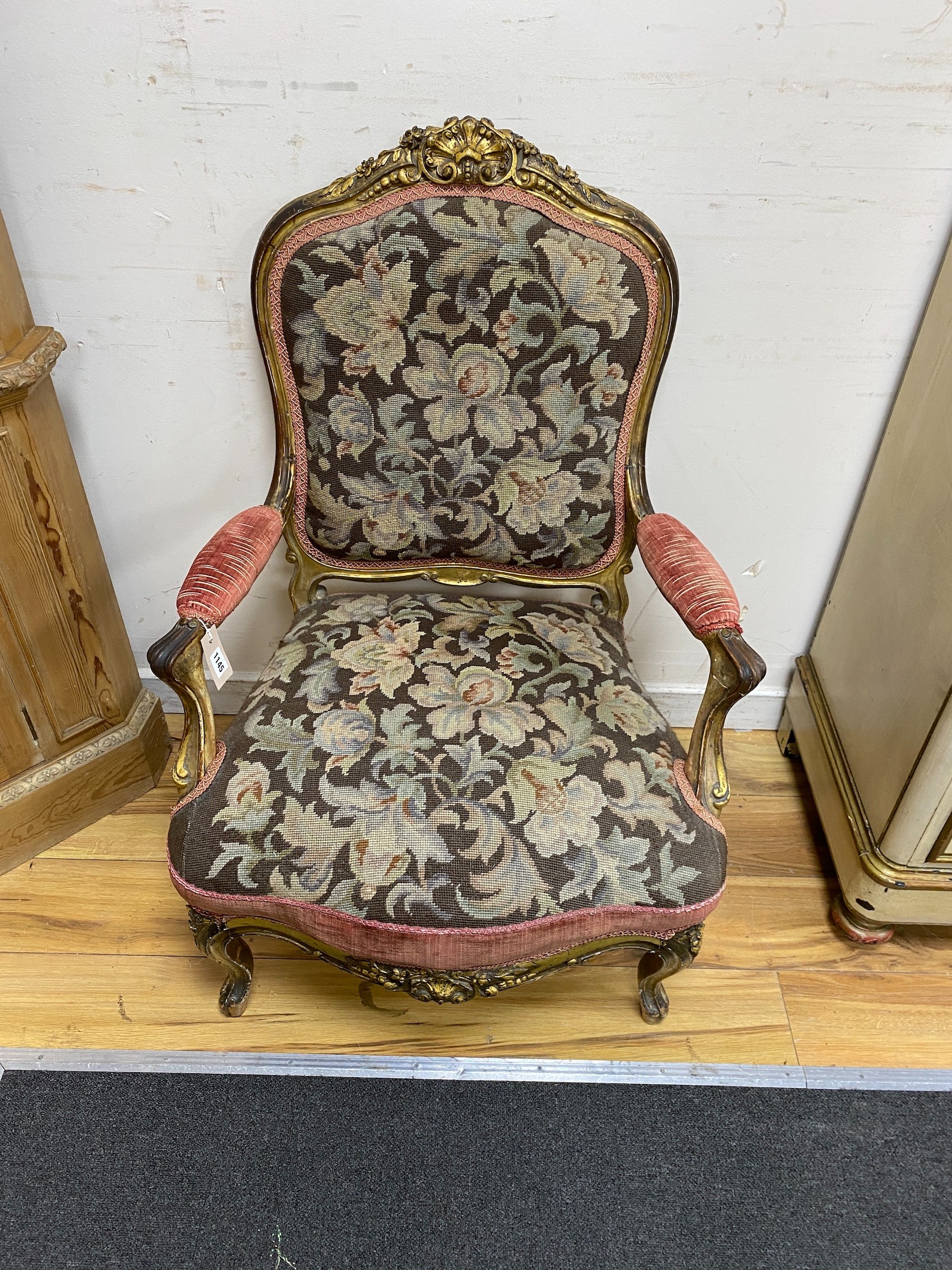 A 19th century French carved giltwood open armchair with floral tapestry upholstery, width 65cm, depth 66cm, height 96cm
